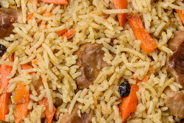 Delicious pilaf with vegetables, salt, spices and herbs in a ceramic plate