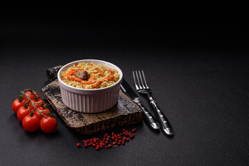 Delicious pilaf with vegetables, salt, spices and herbs in a ceramic plate