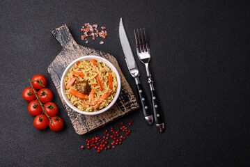 Delicious pilaf with vegetables, salt, spices and herbs in a ceramic plate