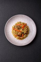 Delicious pilaf with vegetables, salt, spices and herbs in a ceramic plate