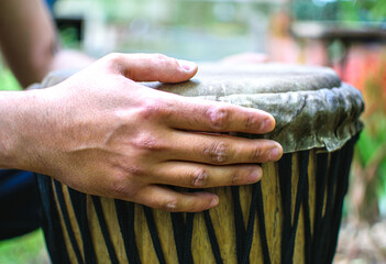 Fototapeta premium Drummer hands playing the ethnic djembe drum.