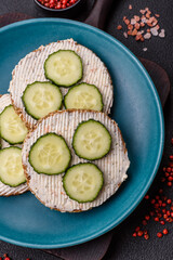 Delicious vegetarian sandwich with grilled toast, cream cheese, cucumbers and seeds