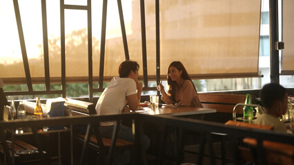 Asian couple eating barbecue in a restaurant
