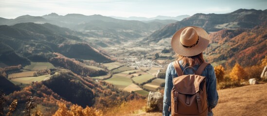 Serene Female Hiker Contemplating Scenic Mountain View with a Backpack - obrazy, fototapety, plakaty