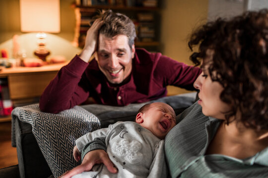 New parents with crying baby at home
