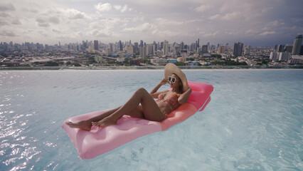 Woman wearing bikini in swimming pool.