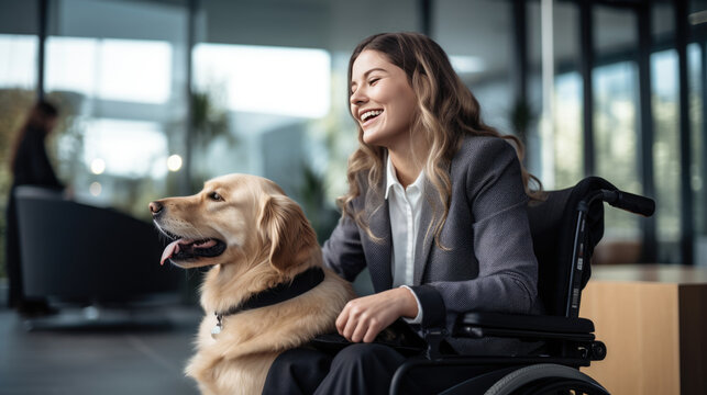 Happy woman in a wheelchair with a joyful service dog by her side in company office.