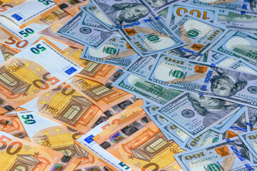 50 euros on top of one hundred dollar bills. Trading Euro with Dollar 1