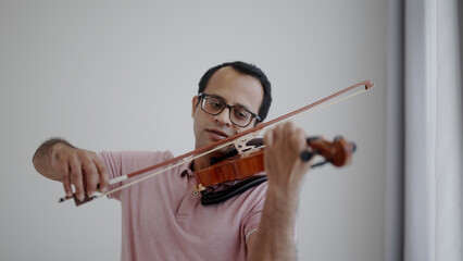 Man playing violin at home