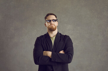 Lucky person. Portrait of a proud, funny and cool man with pixel glasses on a gray background....
