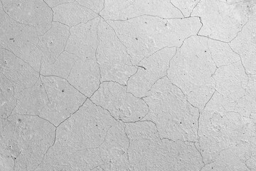 cracked concrete wall covered with gray cement surface as background