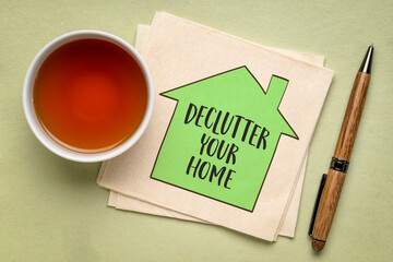 declutter your home motivational reminder - handwriting and sketch on a napkin with a cup of tea, simplicity and minimalism concept