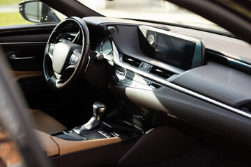 Prestige modern car. Inside car interior with front leather seats, steering wheel, windows,...