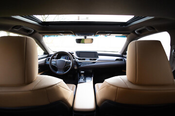 Panoramic glass sun roof in the car. Sliding panoramic sunroof and luxurious leather seats....