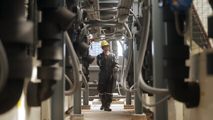 Engineer inspects pipes in a factory - 758250912