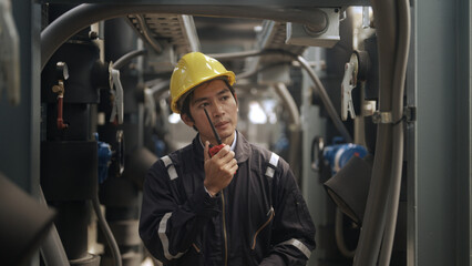 Engineer inspects pipes in a factory
