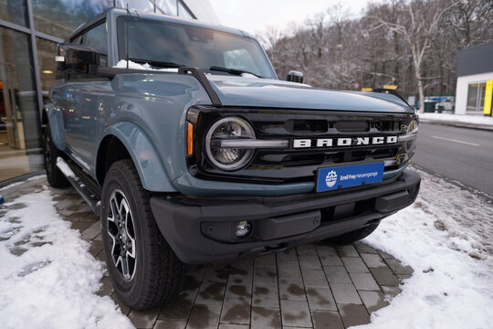 blue Ford Bronco SUV in winter parking lot, American manufacturer Ford in USA, technological advancements in automotive industry, high-performance Raptor vehicle, Frankfurt - January 19, 2024