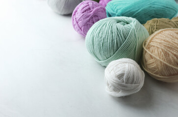 Colorful yarn balls on light background                