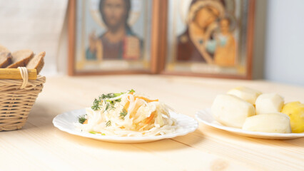 Holy Week, End, Palm Sunday, Good Friday, Easter Sunday Concept. Orthodox food in Great Christian Lent, Lenten food on a wooden table against the background of Orthodox icons.