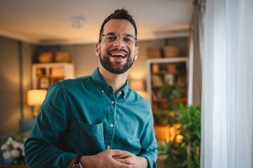 portrait of One adult man with eyeglasses stand at home happy smile