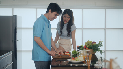 newly married couple cooking together