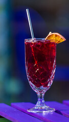 red and yellow cocktail on table outdoor