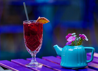 red and yellow cocktail on table outdoor