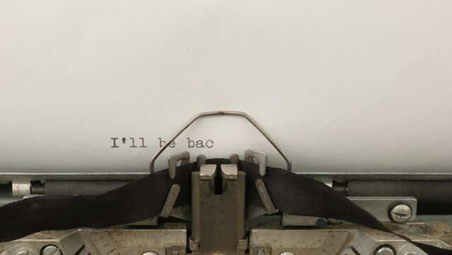 typing a famous catchphrase I'll be back on a vintage typewriter close-up