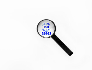 Magnifying glass zooming on ISO26262 Functional Safety sign related to Hazards prevention via Automotive software