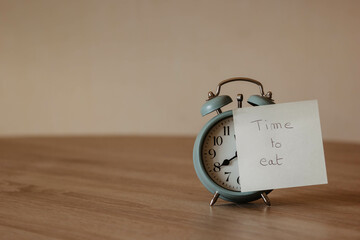 Alarm-clock with post-it and the word 