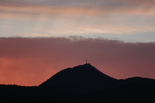 Puy de dôme. sunset and Puy de Dôme. sunset at Puy de Dôme. Pink sky. Silhouette of Puy de dôme. Auvergne. France. view of the volcano in the evening