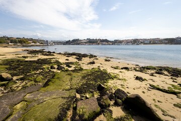 The mouth of the Douro River into the Atlantic Ocean at low tide the last bridge visible stones...