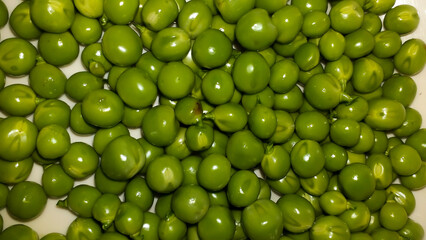 open pea pod with green beans in it.