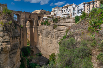 New bridge (Puente Nuevo) and the famous white houses on the cliffs in the city Ronda, Andalusia, Spain.