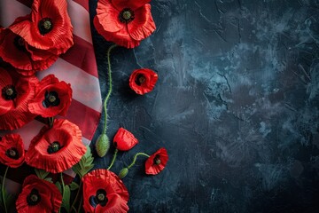 A bunch of red poppies are on a american flag. The flag is placed on a dark blue background. Memorial day concept