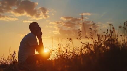 Muslim man praying at sunset