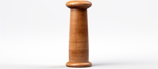 An antique wooden pillar with a finial is elegantly displayed on a white pedestal, showcasing it as a unique art artifact. The hardwood serveware adds a touch of fashion accessory to the space