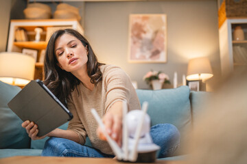 One woman use digital tablet to adjust install home security camera