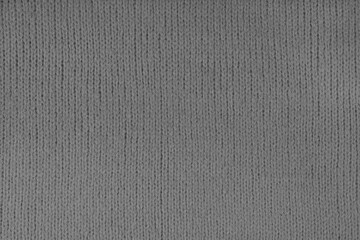Fototapeta na wymiar Gray knitted woolen jersey fabric, sweater, pullover texture background. Fabric abstract backdrop, cloth wallpaper