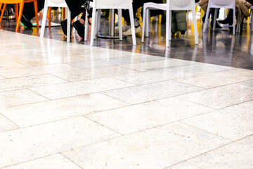 glossy marble flooring in a supermarket tables and chairs in a cafe