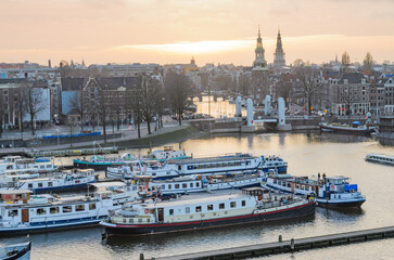 Fototapeta premium Oosterdok canal and cruise boats moored overnight, Amsterdam 2024-Februar-01