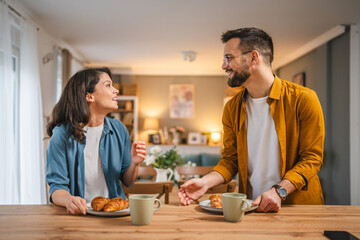 Adult couple have breakfast and cup of coffee at home morning routine