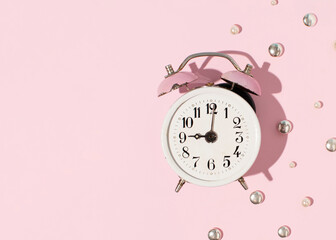 Metal alarm clock, vintage copy, creative composition, morning wake up, 9 o'clock.
