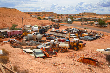 Junkyard of rusty abandoned vintage cars in the desert of the Australian outback of the red center...