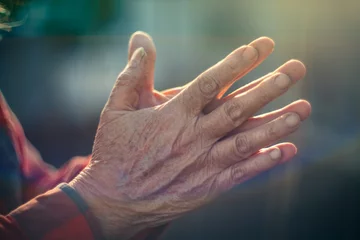 Photo sur Plexiglas Vielles portes Old person hands put together in prayer gesture. Closeup, shallow DOF.