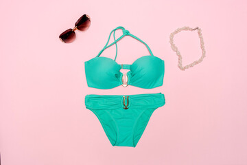 Green bikini with sunglasses and necklace