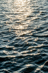 Ripple and motion of river with bright points of light reflecting sunlight