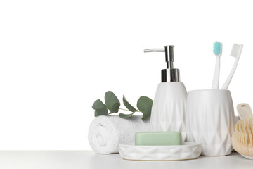 Fototapeta na wymiar Bath accessories. Different personal care products and eucalyptus branch on table against white background. Space for text
