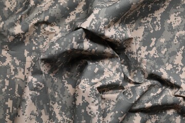 Texture of crumpled camouflage fabric as background, top view