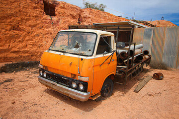 Rusty orange truck in the rugged desert outside the Old Timers Mine in Coober Pedy, South Australia